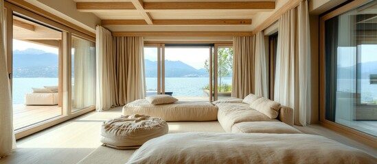 Bohemian style seaside apartment interior with neutral furniture and large windows creating a serene, open space for relaxation and natural light