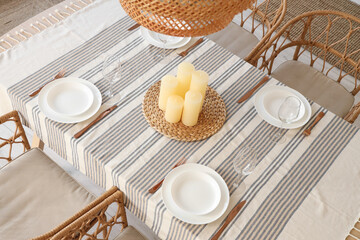 Table setting with candles in dining room