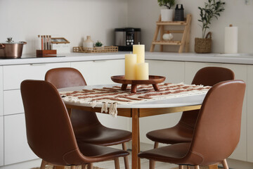 Candles on round table in modern kitchen