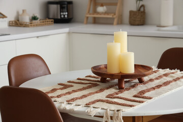 Candles on round table in modern kitchen