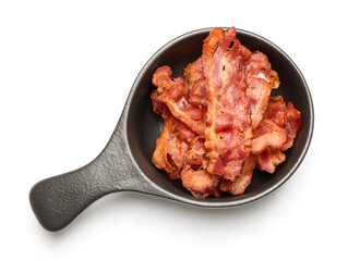 Frying pan with fried bacon rashers on white background