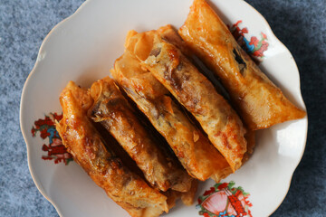 Pisang coklat, piscok, or pisang caramel is a sweet Indonesian snack in white plate 