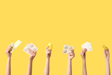 Female hands with mustard plasters, pills, pill boxes and medical mask on yellow background