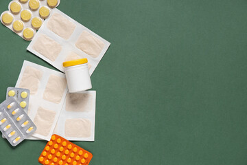 Mustard plasters with pills on green background