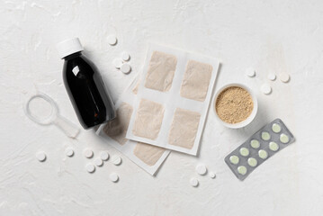 Mustard plasters with medicines on white grunge background