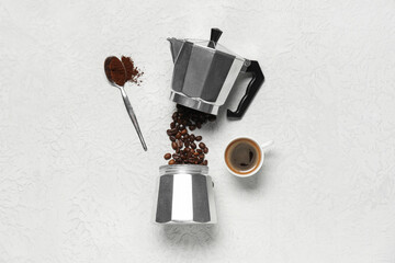 Geyser coffee maker with cup, powder and beans on white background