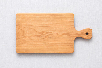 Handmade cherry wood chopping board. wooden cutting board. Empty cherry wood chopping board on...