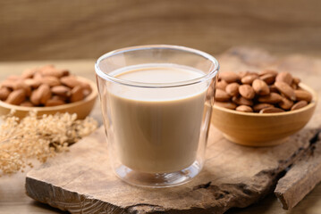 Almond milk in cup glass on wooden background, Alternative milk made from plant, non dairy