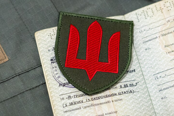 Ukrainian military ID and a record in it about demobilization from the Ukrainian army. Demobilization (dismissal) from military service. Territorial recruitment center. TR (TSK). Documents of a servic