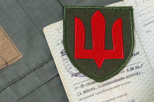 Ukrainian military ID and a record in it about demobilization from the Ukrainian army. Demobilization (dismissal) from military service. Territorial recruitment center. TR (TSK). Documents of a servic