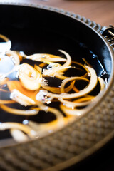 Boiled many onion in hot black soup for cooking sukiyaki. Japanese Sukiyaki hot pot