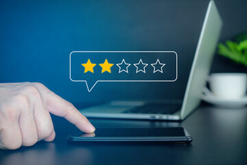 Negative customer review concept. Man a smartphone to give a one-star rating, symbolizing customer dissatisfaction, negative feedback, and online reviews in business reputation. 2 star score,