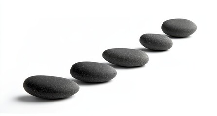 Five smooth, dark grey stones in a row on a white background.