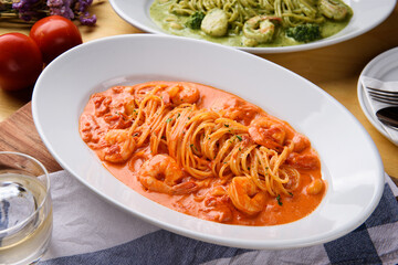 Shrimp tomato rose pasta in a white bowl
