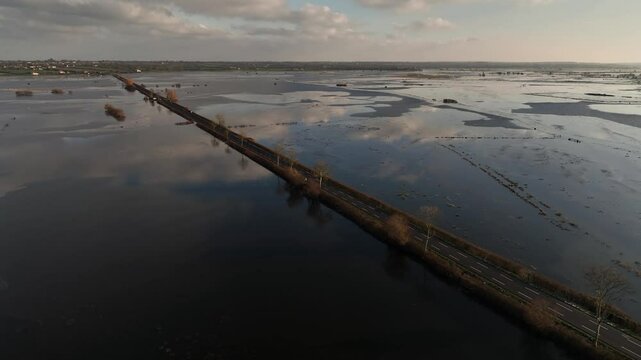 a beautiful aerial shot of a road on the marshes in normandy