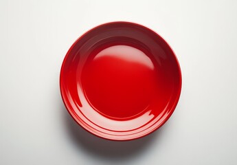 Red round plate on white background.