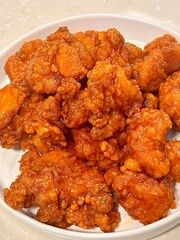 Crispy Korean fried chicken, perfectly glazed with a sweet and spicy sauce. Ideal for food photography and menus, showcasing the irresistible crunch and flavor of this beloved dish.
