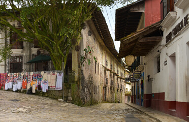 Streets and alleys of Cuetzalan, on the sidewalk exhibited typical textiles of the region