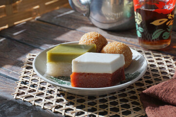 Assorted Traditional Malay Kuih. Seri Muka, Talam Gula Merah, and Kuih Bom on a Serving Plate.