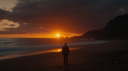 Solitary Figure Contemplates Ocean Sunset Silhouette