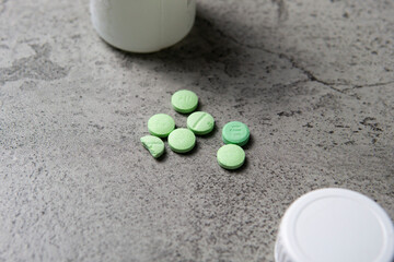 Lot of medicine pills on gray background