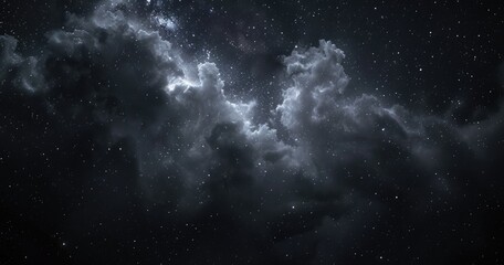 Obraz premium A dark, star-filled sky with ethereal clouds, evoking a sense of wonder and exploration.