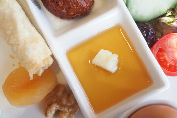 Delicious Turkish Breakfast Platter with Honey, Cheese, Nut, and Fresh Vegetables