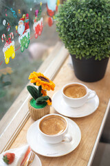Hot coffee placed on the table with beautiful decorations, taken on the side.