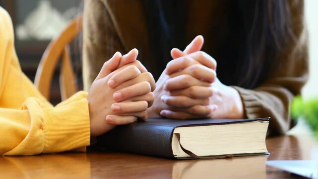 Christian worship and praise. Two young woman are praying and worshiping