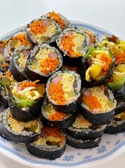 Delicious kimbap rolls filled with fresh vegetables, seasoned rice, and savory proteins, all wrapped in crisp seaweed. A perfect combination of flavor and texture in every bite.

