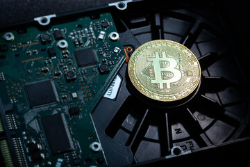 Bitcoin coin lies on the hard drive. Security concept