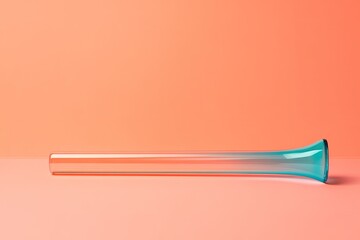 brightly colored noisemaker lying on smooth coral background with soft reflections and subtle lighting