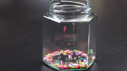 Colorful Sprinkles Filling a Glass Jar - Powered by Adobe