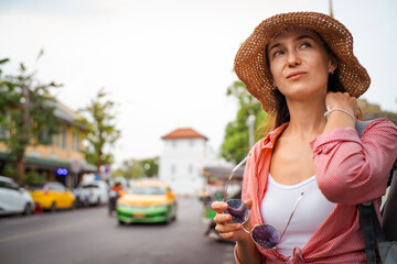 Fototapeta premium Beautiful tourist woman backpack travel in temple and local city