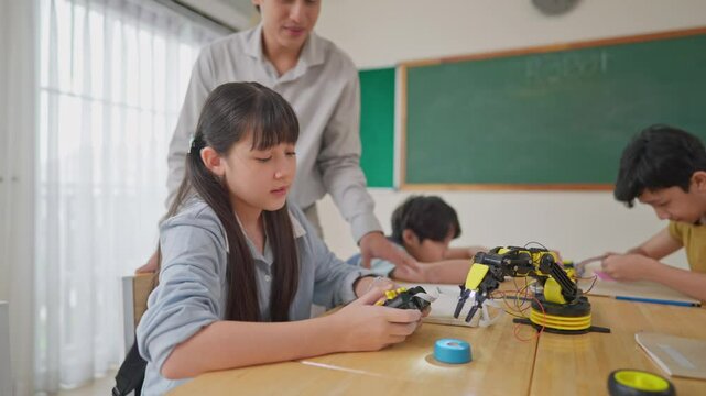 Group of students learning in a robotics class at elementary school.