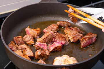 angle view beef dices being cooked