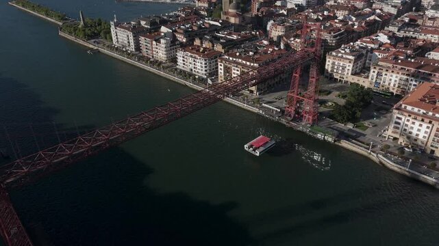 Vizcaya transporter bridge and its gondola linking Portugalete and Las Arenas towns on Nervion River, Drone shot