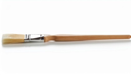 Close-up of a paintbrush with natural bristles and a wooden handle.