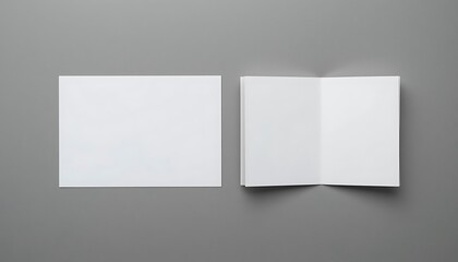 Fototapeta premium Blank white square flyer and open bifold brochure mockup on grey background, perfect for design presentations and branding projects.