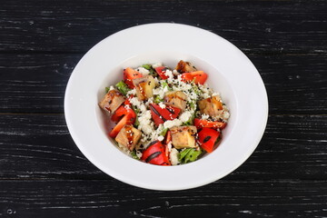 Turkish traditional choban salad on black wooden background