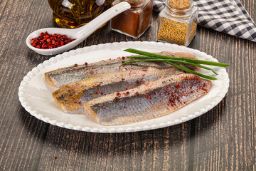 Salted marinated herring fillet with spices