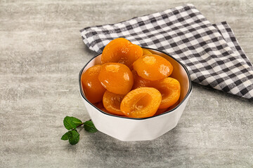 Sweet canned apricots with syrope