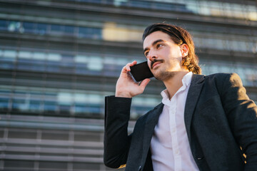 Professional Businessman Using Mobile Phone Outdoors Discussing Corporate Deals And Agreements With A Focus On Technology And Modern Business Communication  