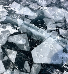blue transparent beautiful ice of Lake Baikal - a winter miracle of nature. abstract frozen...