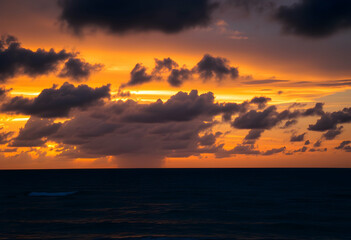Obraz premium Dramatic sunset over ocean, Vibrant orange and gold sky, Dark stormy clouds, Calm sea reflections, Moody seascape, Twilight horizon, Atmospheric cloudscape, Serene coastal scene, Rich color palette, 
