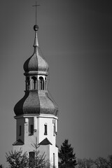 Towering church steeple stands against a clear sky showcasing architectural beauty and historical significance