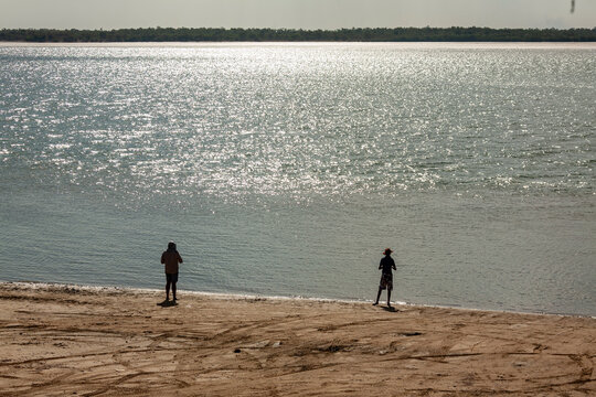 two fishing people beach