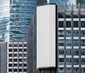 Gray vertical large LED display billboard on building with cityscape background