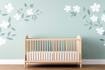 A cozy nursery featuring a wooden crib against a soft green wall adorned with floral decals, creating a serene environment for a baby.