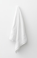 White towel hanging on hook against white wall.